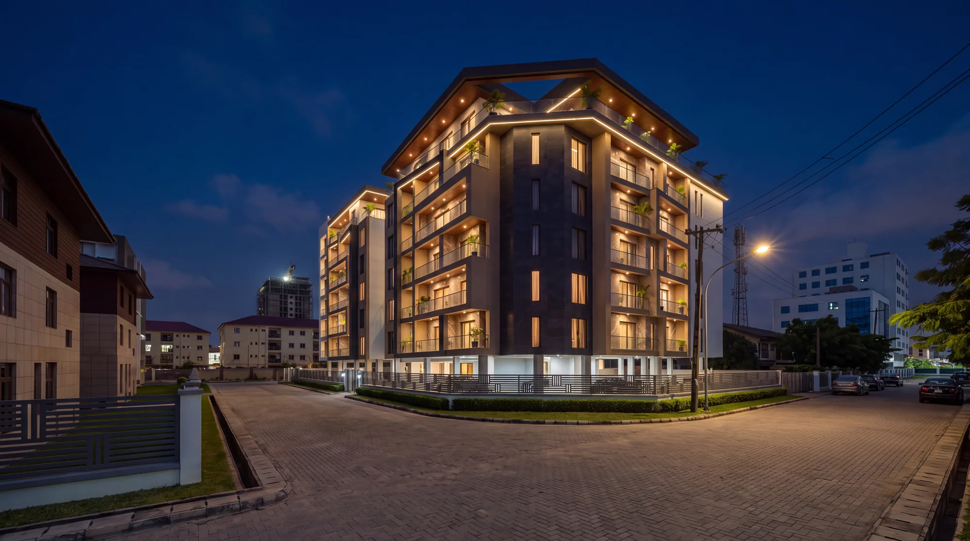The same view at night, balconies and soffits lit